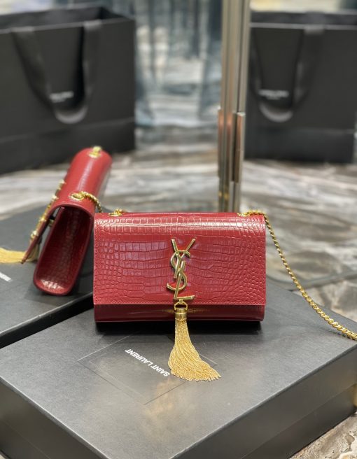 SAINT LAURENT Small 'Kate' Bag with Tassel. Original Quality Bag including gift box, care book, dust bag, authenticity card. Monogram Saint Laurent bag adorned with a curb chain, interlocking YSL initials in metal, and a metallic tassel. Crafted from leather, this Kate shoulder bag from Saint Laurent is decorated with a signature YSL monogram plaque and a hanging tassel detail to the front for an extra refined touch. The perfect go-to for a night out. Featuring a chain shoulder strap, a foldover top with magnetic closure, a main internal compartment, an internal slip pocket, an internal logo patch, an internal logo stamp, and metal hardware. | CRIS&COCO Authentic Quality Designer Bags and Luxury Accessories