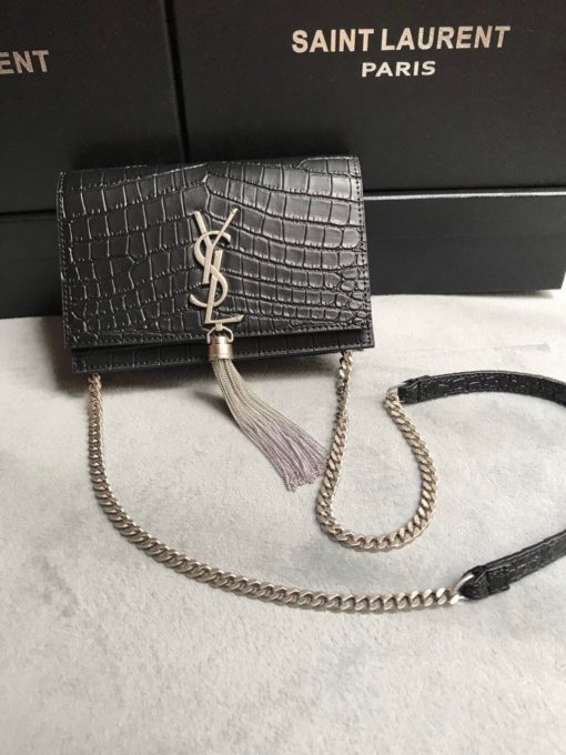 SAINT LAURENT Small 'Kate' Bag with Tassel. Original Quality Bag including gift box, care book, dust bag, authenticity card. Monogram Saint Laurent bag adorned with a curb chain, interlocking YSL initials in metal, and a metallic tassel. Crafted from leather, this Kate shoulder bag from Saint Laurent is decorated with a signature YSL monogram plaque and a hanging tassel detail to the front for an extra refined touch. The perfect go-to for a night out. Featuring a chain shoulder strap, a foldover top with magnetic closure, a main internal compartment, an internal slip pocket, an internal logo patch, an internal logo stamp, and metal hardware. | CRIS&COCO Authentic Quality Designer Bags and Luxury Accessories