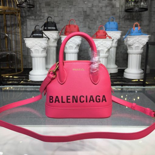 BALENCIAGA Mini Ville Logo Leather Bag. Original Quality Bag. Authentic Epi leather. Metal Toned Hardware. BALENCIAGA Sales Box and Dust Bag. Authenticity Card. BALENCIAGA's Ville mini bowling bag is crafted of grained calfskin printed with a large statement logo at the front and back. This design works as a zipped-top construction with a padlock charm to ensure your valuables are securely stowed. The versatile style can be carried by its rolled handles or over the shoulder via a detachable flat strap. | CRIS&COCO Authentic Quality Designer Bags and Luxury Accessories