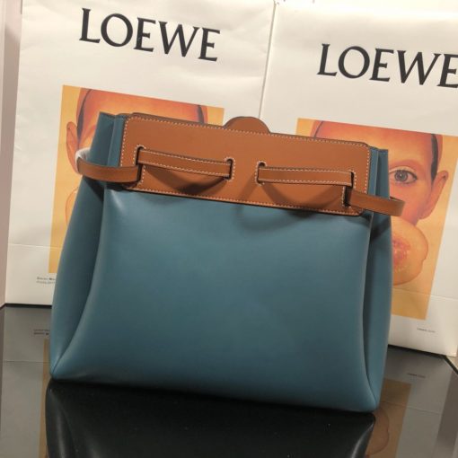 LOEWE Lazo Top Handle Bag. Authentic Quality Bag with literature, gift box, dust bag and authenticity card. A highly chic and sophisticated bag, the Lazo features the recognizable emblematic Gate knot. Contrasting calfskin straps holds the bag, cinching to fasten the bag effortlessly. Creating a sinuous accordion soft silhouette with soft natural calfskin, this novel interpretation is the next must-have chic functional bag of the season. The soft and slouchy calfskin bag is devoid of any zips for the closure and instead relies on the contrasting calfskin straps to cinch and fasten the opening. A relaxed update on a classic bag design. | CRIS&COCO Authentic Quality Designer Bags and Luxury Accessories