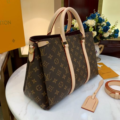 LOUIS VUITTON Soufflot. High-end quality bag including gift box, literature, dust bag, authenticity card. Made from Monogram canvas and featuring two lateral leather bands inspired by the iconic Keepall, the new Soufflot MM has a spacious, well-organized interior. It can be carried by hand and on the elbow with its articulated leather top handles, or on the shoulder, thanks to its removable and adjustable shoulder strap. | CRIS&COCO Authentic Quality Designer Bags and Luxury Accessories