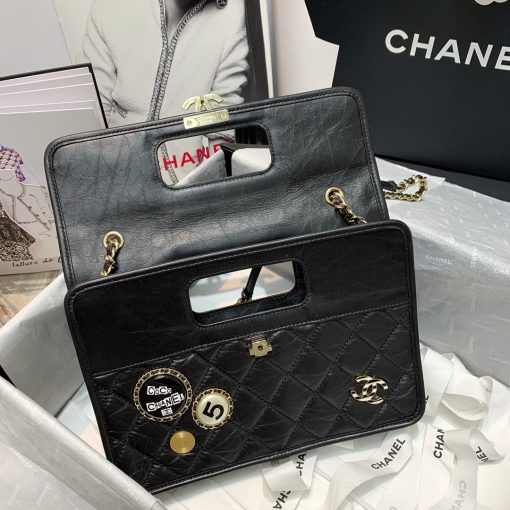 CHANEL Flap Bag with Charms, best high-end quality bag with gift box, dust bag, authenticity card, and CHANEL cloth flower. We love the square-shaped design with a built-in handle for hand carry. Charms give the bag a Punk feel. The center features the CC logo and a woven leather chain strap allows for shoulder carry. | Cris and Coco authentic quality designer bags and luxury accessories.