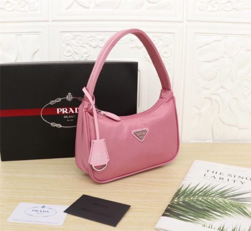 PRADA Re-Edition 2000 Nylon Mini Hobo. High-End Bag including gift box, dust bag, literature, and authenticity card. Practical and feminine, the nylon mini bag is decorated with iconic Saffiano leather trim. It features a contemporary mix of materials. | CRIS and Coco High-End Luxury Accessories