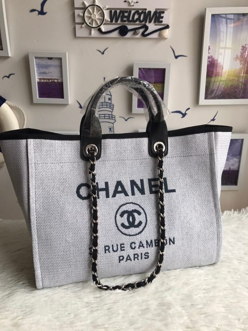 CHANEL Large Deauville Shopping Bag 2021. Authentic quality bag including gift box, booklet, dust bag, authenticity card. The CHANEL Deauville tote matured to a signature CHANEL bag. The bestseller Deauville often appears in seasonal launches in unexpected colors and materials. On the CHANEL website, Chanel calls it the Shopping Bag, but if you walk into a CHANEL boutique and ask for the Deauville, you will be directed to this tote bag. | Cris and Coco Authentic Quality Designer Bags and Luxury Accessories