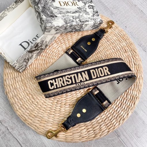 DIOR Christian Dior Shoulder Strap. Original Quality Strap including gift box, care book, dust bag, authenticity card. The 'Christian Dior' signature is featured at the center of the slender shape, framed by black calfskin on either side. Two antique gold-finish metal snap hooks attach the strap to the bag of choice. The strap may be worn over the shoulder or crossbody for a highly personalized style. | CRIS&COCO Authentic Quality Designer Bags and Luxury Accessories