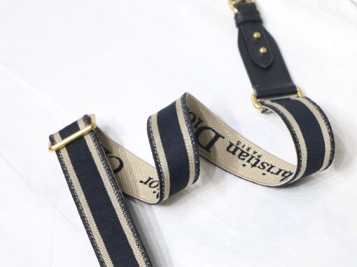 DIOR Christian Dior Shoulder Strap. Original Quality Strap including gift box, care book, dust bag, authenticity card. The 'Christian Dior' signature is featured at the center of the slender shape, framed by black calfskin on either side. Two antique gold-finish metal snap hooks attach the strap to the bag of choice. The strap may be worn over the shoulder or crossbody for a highly personalized style. | CRIS&COCO Authentic Quality Designer Bags and Luxury Accessories