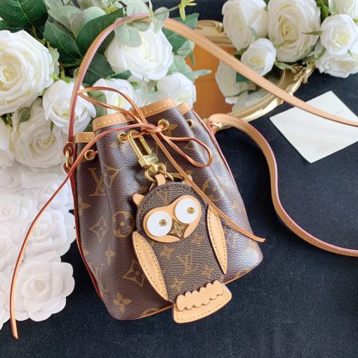 LOUIS VUITTON Owl Bag-Charm & Key Holder. Original Quality Charm including gift box, care book, dust bag, authenticity card. The mascot on the Owl bag charm and key holder is brought to life with LV studs for eyes and a Monogram Flower beak. Gold-color hardware joins calf leather and Monogram Eclipse canvas in a playful mingling of the House's signature materials. The hook and ring on this are both engraved with the Louis Vuitton signature for an elegant finish. | CRIS&COCO Authentic Quality Designer Bags and Luxury Accessories