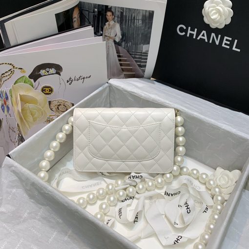 Chanel Wallet on Chain (WOC) Pearls. Original Quality Bag including gift box, care book, dust bag, authenticity card. This style is part of Chanel’s Fall/Winter 2020 Collection. The classic lambskin wallet on chain gets a chic new update with a strap adorned with imitation pearls. It is available in the regular size. The pearl strap is one of the most popular designs from the collection. Chanel’s iconic pearls brings in an elegant touch on the casual WOC. It can be worn as an everyday bag or used as an evening bag. | CRIS&COCO Authentic Quality Designer Bags and Luxury Accessories