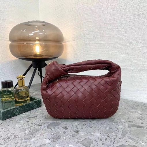 BOTTEGA VENETA The Jodie Hobo Bag. Original Quality Bag including gift box, care book, dust bag, authenticity card. This rounded mini hobo bag in woven leather is woven by hand with a curved, seamless structure. It has Iconic Intrecciato 15 weaves in a subtly amplified new dimension. This bag is soft, draped shape with knot detail on the handle. | CRIS&COCO Authentic Quality Designer Bags and Luxury Accessories