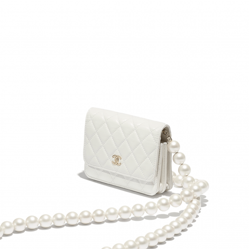 Chanel Wallet on Chain (WOC) Pearls. Original Quality Bag including gift box, care book, dust bag, authenticity card. This style is part of Chanel’s Fall/Winter 2020 Collection. The classic lambskin wallet on chain gets a chic new update with a strap adorned with imitation pearls. It is available in the regular size. The pearl strap is one of the most popular designs from the collection. Chanel’s iconic pearls brings in an elegant touch on the casual WOC. It can be worn as an everyday bag or used as an evening bag. | CRIS&COCO Authentic Quality Designer Bags and Luxury Accessories