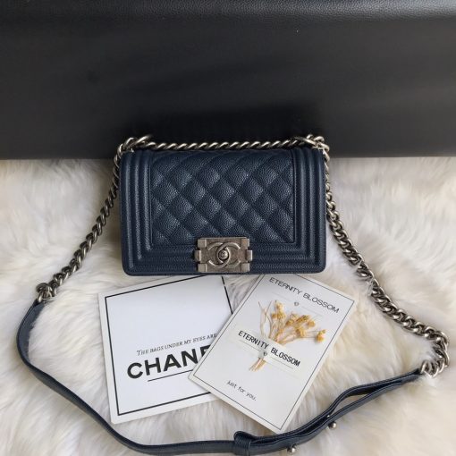 CHANEL Small Boy Handbag. Original Quality Bag including gift box, care book, dust bag, authenticity card. Even though the Boy was only introduced in 2011, the style has quickly achieved the status of an icon. Designed by Karl Lagerfeld and named after Boy Capel, the now legendary love of Coco Chanel’s life, the bag encapsulates masculine chic conveyed through rigid structure, boxy shape and sharp corners. This CHANEL Small Handbag is instantly recognizable for its simple, boxy silhouette and sharp corners, embellished only with a contrasting, bold-looking link chain strap which is the main feature of the bag. This most popular variations of the Chanel Boy are available in either caviar or lambskin. There are no external pockets and the sole adornment is the quilted fascia. | CRIS&COCO Authentic Quality Designer Bags and Luxury Accessories