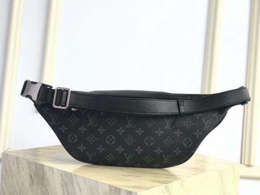 LOUIS VUITTON Discovery Bum Bag. Combining casual sophistication with contemporary practicality, the Discovery Bumbag is the perfect city companion. It is fashioned from Monogram Eclipse canvas/Monogram Shadow leather and adorned with zipped pockets on the front and back for easy access. With its adjustable belt and body-friendly design, it can be worn stylishly slung across the chest, draped over the shoulder or simply strapped around the waist.| CRIS&COCO Authentic Quality Designer Bags and Luxury Accessories