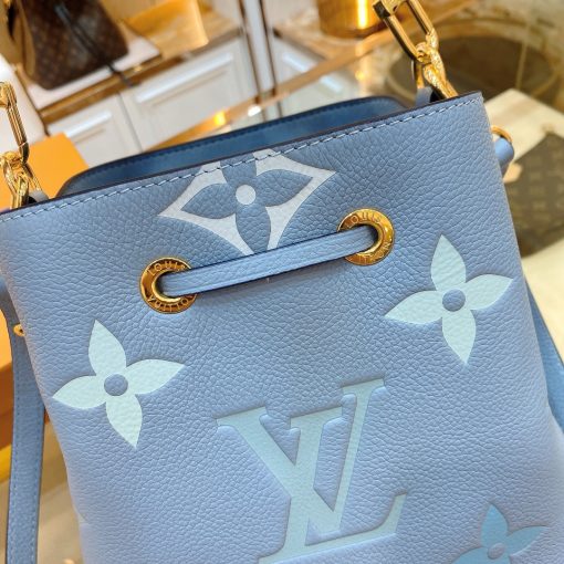 LOUIS VUITTON NéoNoé BB. Made from two-color Monogram Empreinte leather, the gradient pastel colorway of the Monogram Giant motif brings a festival feel to this resolutely on-trend NéoNoé BB bucket bag. It features a detachable top handle for hand and elbow carry as well as an adjustable strap for hand carry and over-the-shoulder wear. | CRIS&COCO Authentic Quality Designer Bags and Luxury Accessories