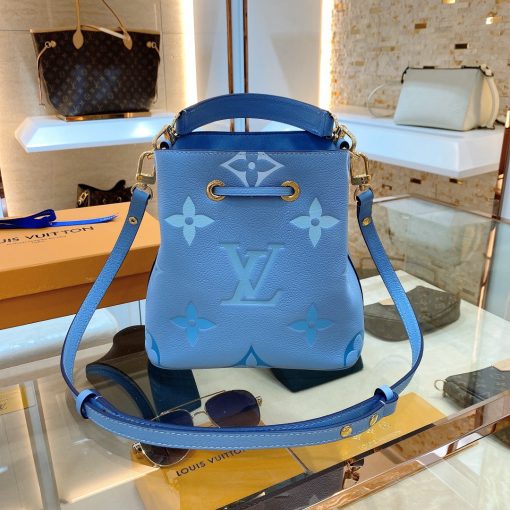 LOUIS VUITTON NéoNoé BB. Made from two-color Monogram Empreinte leather, the gradient pastel colorway of the Monogram Giant motif brings a festival feel to this resolutely on-trend NéoNoé BB bucket bag. It features a detachable top handle for hand and elbow carry as well as an adjustable strap for hand carry and over-the-shoulder wear. | CRIS&COCO Authentic Quality Designer Bags and Luxury Accessories