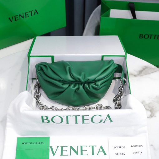 BOTTEGA VENETA Belt Chain Pouch. Fashion can be functional too and this Belt Chain pouch from Bottega Veneta is proof of that. It's perfect for days when you want to go hands-free. This smaller pouch in soft leather with one main compartment inside, leather interior, metal frame fastening, adjustable chain strap with carabiner fastening. Can be worn as a belt bag or crossbody. | CRIS&COCO Authentic Quality Designer Bags and Luxury Accessories