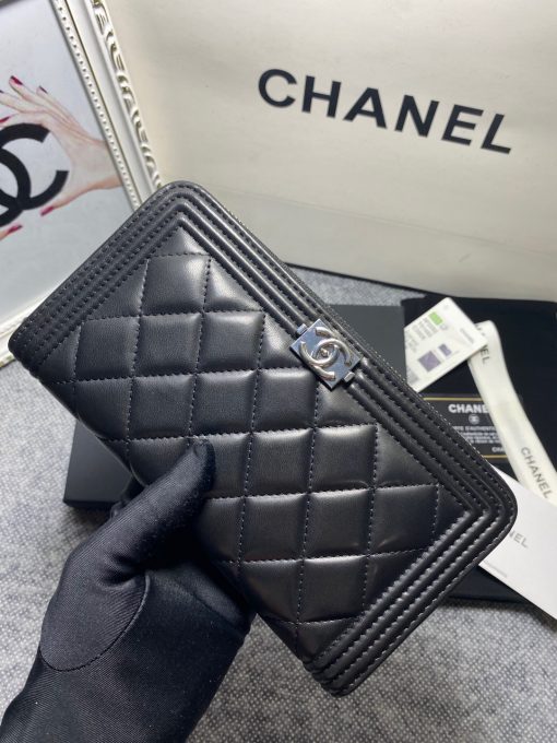 CHANEL 'Boy' Long Zipped Wallet. Original Quality Wallet with literature, dust bag, box and authenticity card. The Chanel 'Boy' Wallets have always been as popular as the Boy Chanel Quilted Bags. Everything about the design resemble to the Boy Bag line including the quilting with stripes on the edges and the boy clasp as well. The calfskin/lambskin makes sure that you don’t need to constantly babying it and it will not get damaged so easily if it sits next to your keys, inside your bag. This wallet is practical and amazing; perfect to hold paper money, credit cards and coins.| CRIS&COCO Authentic Quality Designer Bags and Luxury Accessories