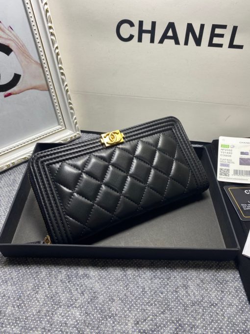 CHANEL 'Boy' Long Zipped Wallet. Original Quality Wallet with literature, dust bag, box and authenticity card. The Chanel 'Boy' Wallets have always been as popular as the Boy Chanel Quilted Bags. Everything about the design resemble to the Boy Bag line including the quilting with stripes on the edges and the boy clasp as well. The calfskin/lambskin makes sure that you don’t need to constantly babying it and it will not get damaged so easily if it sits next to your keys, inside your bag. This wallet is practical and amazing; perfect to hold paper money, credit cards and coins.| CRIS&COCO Authentic Quality Designer Bags and Luxury Accessories