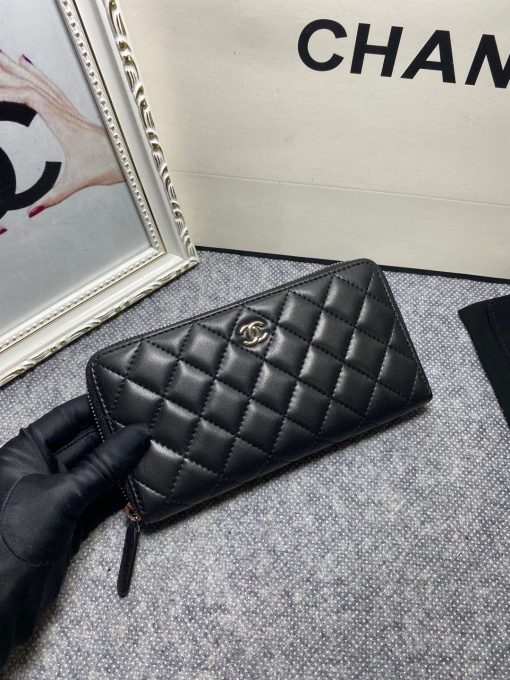 CHANEL Classic Long Zipped Wallet.  Original Quality Wallet including gift box, care book, dust bag, authenticity card. This wallet is one of the signature wallets of Chanel. It has been around for some time now and it will continue to stick around. This wallet is practical and amazing; perfect to hold paper money, credit cards and coins. The classic black color, you will get the signature burgundy colored interior. | CRIS&COCO Authentic Quality Designer Bags and Luxury Accessories