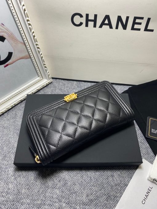 CHANEL 'Boy' Long Zipped Wallet. Original Quality Wallet with literature, dust bag, box and authenticity card. The Chanel 'Boy' Wallets have always been as popular as the Boy Chanel Quilted Bags. Everything about the design resemble to the Boy Bag line including the quilting with stripes on the edges and the boy clasp as well. The calfskin/lambskin makes sure that you don’t need to constantly babying it and it will not get damaged so easily if it sits next to your keys, inside your bag. This wallet is practical and amazing; perfect to hold paper money, credit cards and coins.| CRIS&COCO Authentic Quality Designer Bags and Luxury Accessories