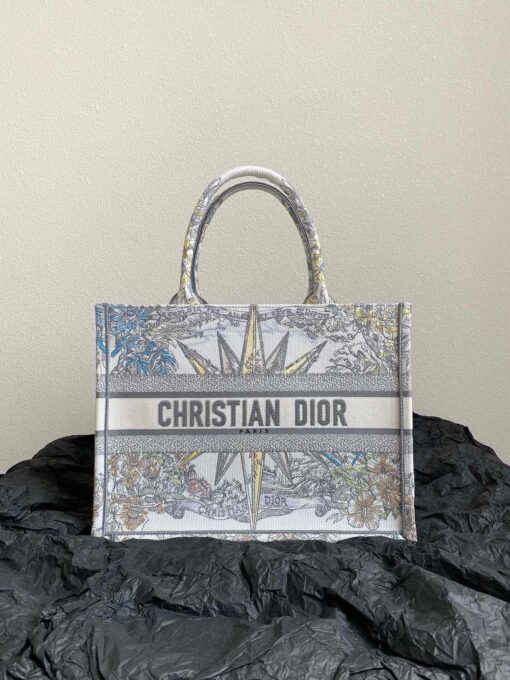 DIOR Book Tote. Original Quality Bag including gift box, care book, dust bag, authenticity card. This Book Tote is an original style introduced by Creative Director Maria Grazia Chiuri. This has become a staple of the Dior aesthetic. Ideally designed to carry all your daily essentials, the small shape is fully embroidered and the 'Christian Dior' signature on the front. This carryall is a perfect example of the Dior savoir-faire and also may be coordinated with a pouch or other small leather goods for a complete look. | CRIS&COCO Authentic Quality Designer Bags and Luxury Accessories