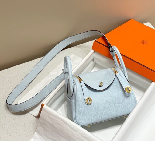 HERMÈS Mini Lindy. High-end quality bag including gift box, literature, dust bag, authenticity card. Maison HERMÈS is elevating the Lindy, with the introduction of the new Mini and is joining the holy Trinity, the Birkin, Kelly, and Constance.| CRIS AND COCO Authentic Quality Luxury Accessories