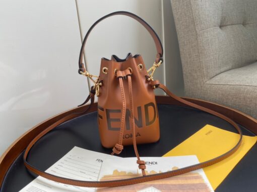 FENDI Mon Tresor Mini Bucket Bag: Style Meets Practicality This Mon Tresor Bag is a chic, minimalist dream. With its drawstring fastening and metal detailing on the sides and eyelets, this bag is as practical as a backpack and can be worn in different ways with its two detachable shoulder straps. It promises a spacious interior and supple leather construction to help store more than the average duffle bag or shoulder bag can manage. Despite it's thoughtfully practical design, it still looks luxurious and glamorous - no wonder it comes with a designer price tag! | CRIS&COCO Authentic Quality Designer Bags and Luxury Accessories