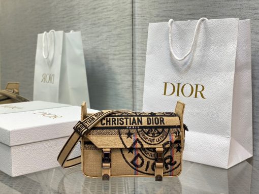 DIOR Small DiorCamp Bag. Original Quality Bag including gift box, care book, dust bag, authenticity card. Maria Grazia Chiuri has updated the classic messenger bag by adding signature Dior details for a relaxed and modern look. Fully embroidered with the Dior Oblique motif, the bag is enhanced by a 'CHRISTIAN DIOR PARIS' signature flap, as well as sportswear-inspired 'CD' buckles. Equipped with an adjustable and removable shoulder strap, the small, compact messenger bag can be worn over the shoulder or crossbody, and will make an ideal urban companion. | CRIS&COCO Authentic Quality Designer Bag and Luxury Accessories