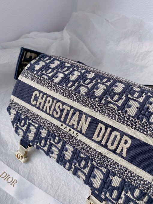 DIOR Small DiorCamp Bag. Original Quality Bag including gift box, care book, dust bag, authenticity card. Maria Grazia Chiuri has updated the classic messenger bag by adding signature Dior details for a relaxed and modern look. Fully embroidered with the Dior Oblique motif, the bag is enhanced by a 'CHRISTIAN DIOR PARIS' signature flap, as well as sportswear-inspired 'CD' buckles. Equipped with an adjustable and removable shoulder strap, the small, compact messenger bag can be worn over the shoulder or crossbody, and will make an ideal urban companion. | CRIS&COCO Authentic Quality Designer Bag and Luxury Accessories