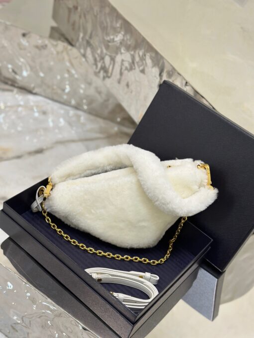 PRADA Shearling Mini Bag. Original Quality Bag including gift box, care book, dust bag, authenticity card. The softness and fuzziness of shearling accentuate the modern, wintry allure of this mini-bag characterized by its harmonious and delicate shape. The bag accented with a chain handle is decorated with the enameled metal triangle logo. | CRIS&COCO Authentic Quality Designer Bags and Luxury Accessories