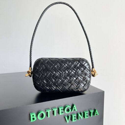 BOTTEGA VENETA Knot On Strap. Original Quality Bag including gift box, care book, dust bag, authenticity card. Bottega Veneta is famous for its intrecciato artistry, done with sophisticated artisanal techniques. And if we ever need the ‘perfect’ shoulder bag, take this Knot On Strap, a classic piece from the house. The design is timeless, but for the newest edition the fashion brand added an innovative glimmer accents, to give the knot bag a luxurious and contemporary edge. The woven panels of iconic Intrecciato and finished with shimmering ayers leather, carefully put together to give each separated piece a unique look and texture. | CRIS&COCO Authentic Quality Designer Bags and Luxury Accessories