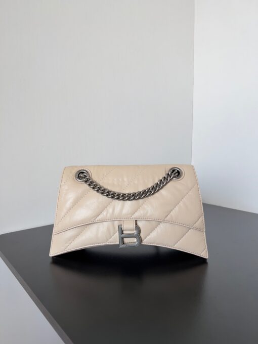 BALENCIAGA Crush Small Chain Bag. Original Quality Bag including gift box, care book, dust bag, authenticity card. Crush on this metallic Crush Chain Bag. This is a new iteration on their celebrated curvilinear design, complete with tonal B logo hardware and shoulder and crossbody chain. Crafted in a contemporary crushed quilted calfskin. | CRIS&COCO Authentic Quality Designer Bags and Luxury Accessories