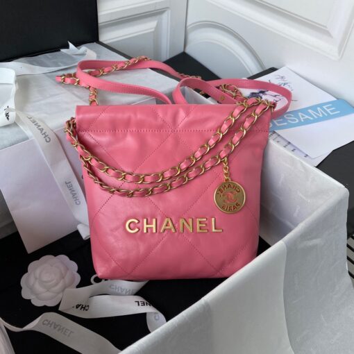 CHANEL 22 Mini Handbag. Original Quality Bag including gift box, care book, dust bag, authenticity card. The Chanel 22 Handbag, has a shape, versatility, and buzz all its own, bringing a casual, even bohemian flare to the always-dressed fashion house. This is crafted of diamond-stitched calfskin leather. The bag features leather threaded silver chain shoulder straps and a matching Chanel logo on the front. The open top with magnetic closure leads to a black fabric interior with a zipper pocket and a removable pouch. | CRIS AND COCO Authentic Quality Luxury Accessories