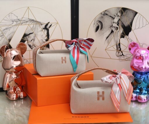 HERMÈS Bride-A-Brace Case. Original Quality Bag including gift box, care book, dust bag, authenticity card. It might have slipped our attention, but we think the Hermes Bride-A-Brace Case is a must have for anyone serious high fashion collectors. This case can be used as a pouch or even for beach and holiday. It can also be used as a toiletry bag and I think the design is adorable. So there is no doubt, the Hermes Bride-A-Brace Case is very popular. These cases are made from canvas with anti-stain water-repellent chevron lining, which is cotton. It’s embroidered with a modern ‘H’ logo on the front. These cases are single colored. And just take a look at the gorgeous details. The handle is designed from the sides to the top. And it’s linked together with what-appears-to-be a push button. We also love the beautiful shape. | CRIS&COCO Authentic Quality Designer Bags and Luxury Accessories