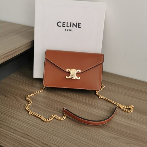 CELINE Wallet On Chain Triomphe. Original Quality Bag including gift box, care book, dust bag, authenticity card. Looking for a reasonable priced high fashion WOC. Take a look at this latest Celine Wallet On Chain from the Spring Summer 2021 Collection. Made from calfskin, this WOC is made for flaunting. The center comes with the famous Triomphe CC logo. There are different colors available, but the bag comes with a chain colored in gold hardware. The chain can also be removed so you can turn it into an evening clutch. You also get a shoulder pad. | CRIS&COCO Authentic Quality Designer Bags and Luxury Accessories