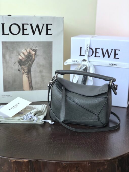 LOEWE Mini Puzzle Bag. Original Quality Bag including gift box, care book, dust bag, authenticity card. The Puzzle bag is the debut bag for LOEWE by Creative Director Jonathan Anderson. A cuboid shape and precise cutting technique create Puzzle’s distinctive geometric lines. This mini version is crafted in contrasting calfskins. | CRIS AND COCO Authentic Quality Luxury Accessories