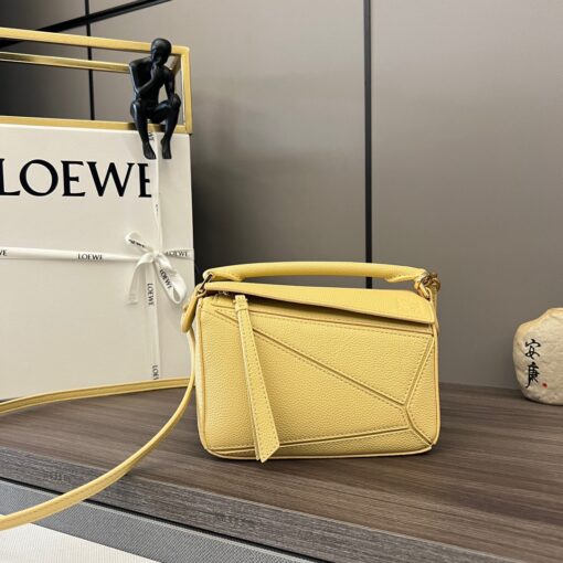 LOEWE Mini Puzzle Bag. Original Quality Bag including gift box, care book, dust bag, authenticity card. The Puzzle bag is the debut bag for LOEWE by Creative Director Jonathan Anderson. A cuboid shape and precise cutting technique create Puzzle’s distinctive geometric lines. This mini version is crafted in contrasting calfskins. | CRIS AND COCO Authentic Quality Luxury Accessories