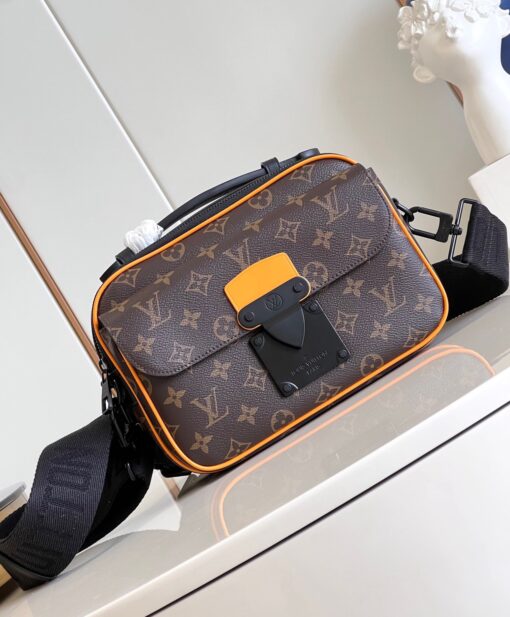 LOUIS VUITTON S Lock Messenger: A Fusion of Timeless Elegance and Modern Style. The S Lock Messenger in Monogram Macassar canvas showcases a unique closure, drawing inspiration from a trunk lock crafted by Georges Vuitton back in 1886. A meticulous finishing technique imparts the magnetic metal clasp with a strikingly contemporary appearance. Moreover, this avant-garde bag boasts a spacious zipped compartment, reminiscent of classic trunks, along with a luxurious leather handle and an iconic LV signature strap. Together, these features render it a fashionable and convenient accessory. | CRIS&COCO Authentic Quality Designer Bags and Luxury Accessories