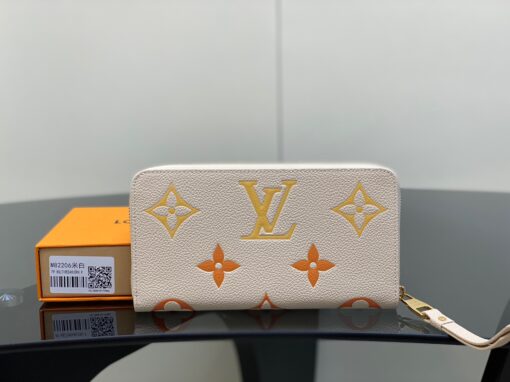 LOUIS VUITTON Zippy Wallet – Where Luxury Meets Functionality. Presenting the exquisite Zippy wallet, a coveted piece from the LV Gradient collection for this season. Meticulously fashioned using grained, embossed Monogram Empreinte leather, it showcases a gracefully transitioning spectrum of summery hues. This iconic wallet is distinguished by its sleek, slender profile, dependable zip closure, and ingeniously designed interior replete with an array of card slots, pockets, and compartments, ensuring both style and functionality in one harmonious package.