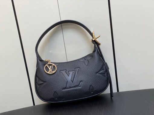 LOUIS VUITTON Mini Moon: The Perfect Compact Bag for Every Occasion. Introducing the Mini Moon, a fashionable and compact micro bag with a shoulder strap, crafted from soft and supple Monogram Empreinte leather. The embossed Monogram pattern adds a touch of sophistication, beautifully adorned with oversized and luxurious details, including the iconic LV Circle signature on the zipper pull. Perfectly suited for both daytime and evening outings, this versatile bag can be effortlessly carried on your shoulder, arm, or even by hand, making it a must-have for storing your essentials.