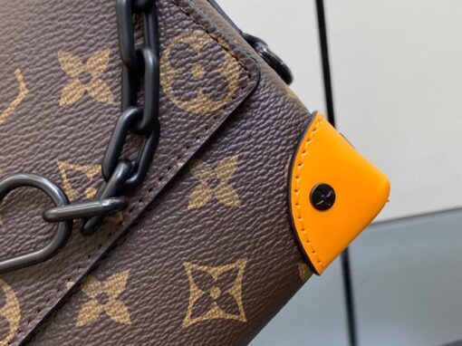 LOUIS VUITTON Steamer Wearable Wallet. Style meets function: Elevate your everyday. The Steamer Wearable Wallet is a tasteful creation that draws inspiration from the timeless design codes of our House's classic Steamer bags. Crafted with utmost precision, this wallet is constructed with durable Monogram Macassar canvas and features reinforced saffron leather corners for added strength. The use of black metal hardware, including rivets on the corners and a steamer-style chain, adds a touch of elegance to this piece. Rest assured, your valuables will be kept safe and organized with the inclusion of an inside zipped pocket.