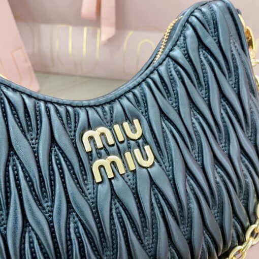 MIU MIU Matelassé Shoulder Bag. Elevate your style with sophistication and craftsmanship. The exquisite matelassé technique exudes elegance and creates a visually captivating, multi-dimensional effect on this nappa leather shoulder bag. The beautifully crafted logo, reflecting the various metallic finishes of the hardware, effortlessly catches the eye, adding a touch of distinction to the immaculate artisanal work. Both functional and aesthetically pleasing, the detachable chain and leather shoulder straps perfectly meet your needs.