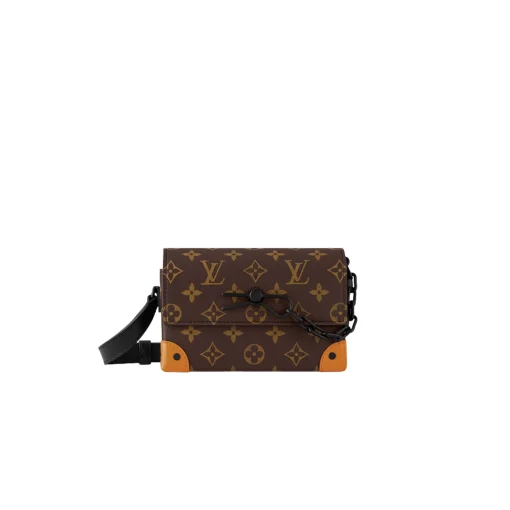 LOUIS VUITTON Steamer Wearable Wallet. Style meets function: Elevate your everyday. The Steamer Wearable Wallet is a tasteful creation that draws inspiration from the timeless design codes of our House's classic Steamer bags. Crafted with utmost precision, this wallet is constructed with durable Monogram Macassar canvas and features reinforced saffron leather corners for added strength. The use of black metal hardware, including rivets on the corners and a steamer-style chain, adds a touch of elegance to this piece. Rest assured, your valuables will be kept safe and organized with the inclusion of an inside zipped pocket.