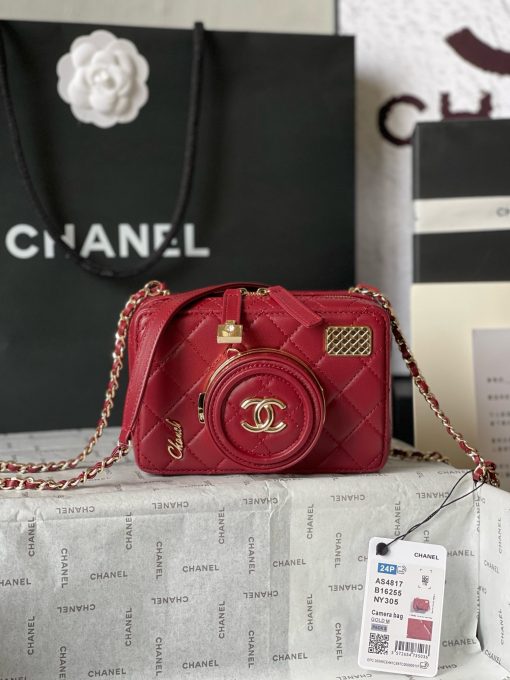 CHANEL Camera Bag. A pinnacle of timeless elegance and contemporary sophistication. This iconic piece showcases exquisite craftsmanship and meticulous attention to detail. The camera bag design exudes versatility and style, offering a modern reinterpretation of a classic silhouette. Made from premium materials, it boasts buttery-soft lambskin leather, adorned with the iconic quilted pattern synonymous with CHANEL's heritage. With its compact yet spacious interior, the Camera Bag effortlessly accommodates all your essentials while maintaining a sleek and streamlined profile. The signature Chanel interlocking CC logo adorns the front, adding a touch of unmistakable luxury to the design.