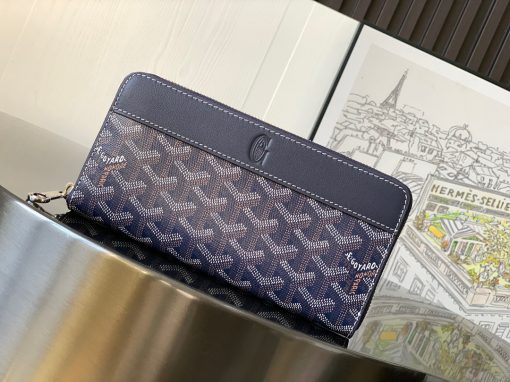 GOYARD Matignon GM Wallet: A Statement of Elegance and Functionality. Experience luxury and functionality with the Goyard Matignon GM Wallet. Crafted from premium calf leather and Goyardine canvas, it offers twelve card slots, a zipper pocket, and two spacious compartments, all secured by a snap button closure. Handcrafted by skilled artisans, Whether you're running errands or gracing a formal occasion, this wallet is the ultimate style companion. Choose from an array of colors to reflect your personality and elevate your ensemble. With this wallet, you'll not only radiate elegance but also experience unparalleled functionality.