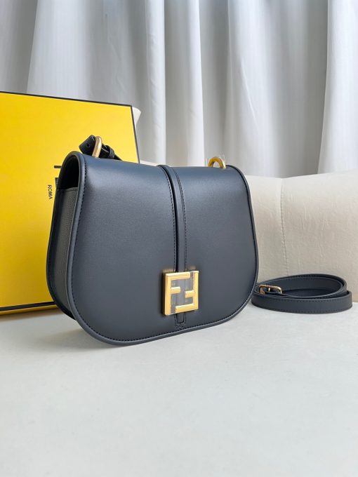 FENDI C’mon Medium. Timeless Elegance, Embodied in Leather. Elegantly designed, this medium-sized satchel bag boasts graceful, curved lines that exude femininity. Its elongated flap is adorned with a striking metal FF logo, adding a touch of sophistication to its overall charm. Crafted from supple leather with meticulously embossed edges and intricate details, this bag radiates a sense of refined luxury. The sides of the bag seamlessly blend with the overall design, crafted from the same tone-on-tone full-grain leather, ensuring a harmonious and visually pleasing aesthetic.