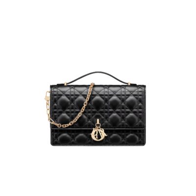 DIOR Miss Dior Top Handle Bag– Your Day to Evening Essential. Elegance in Every Detail. Introducing the latest addition to the Cruise 2024 collection, the Miss Dior Top Handle bag embodies an exquisite blend of sophistication and functionality. Meticulously fashioned from luxurious black lambskin adorned with meticulous Cannage stitching, this bag showcases a gracefully adorned flap adorned by a captivating D.I.O.R. charm. Beneath this flap, you'll discover two spacious compartments and a secure zipped pouch, designed to effortlessly accommodate all your essentials, whether it's day or night. The signature Top Handle of this bag is both elegant and versatile, featuring a removable chain strap with a leather insert. This thoughtful design allows you to carry it comfortably in hand, wear it gracefully over your shoulder, or effortlessly sling it across your body for a stylish and adaptable look.