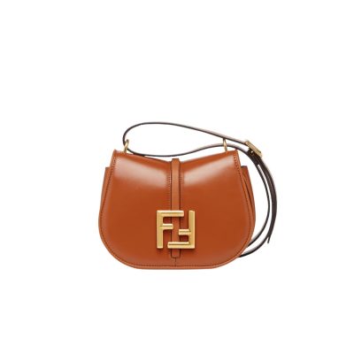 FENDI C’mon Mini. Embrace Elegance: Stefano Pilati's Curvaceous Creation. A petite satchel bag, graced with graceful, feminine curves, represents a masterpiece from the illustrious collection envisioned by the renowned Stefano Pilati. Fashioned from sumptuously smooth leather, this exquisite piece is adorned with meticulously embossed accents and edges, culminating in a striking FF logo proudly showcased on its elegant flap.