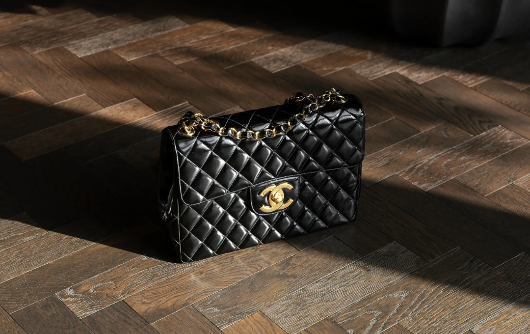 The CHANEL Classic Flap Bag in black leather with gold chain accents