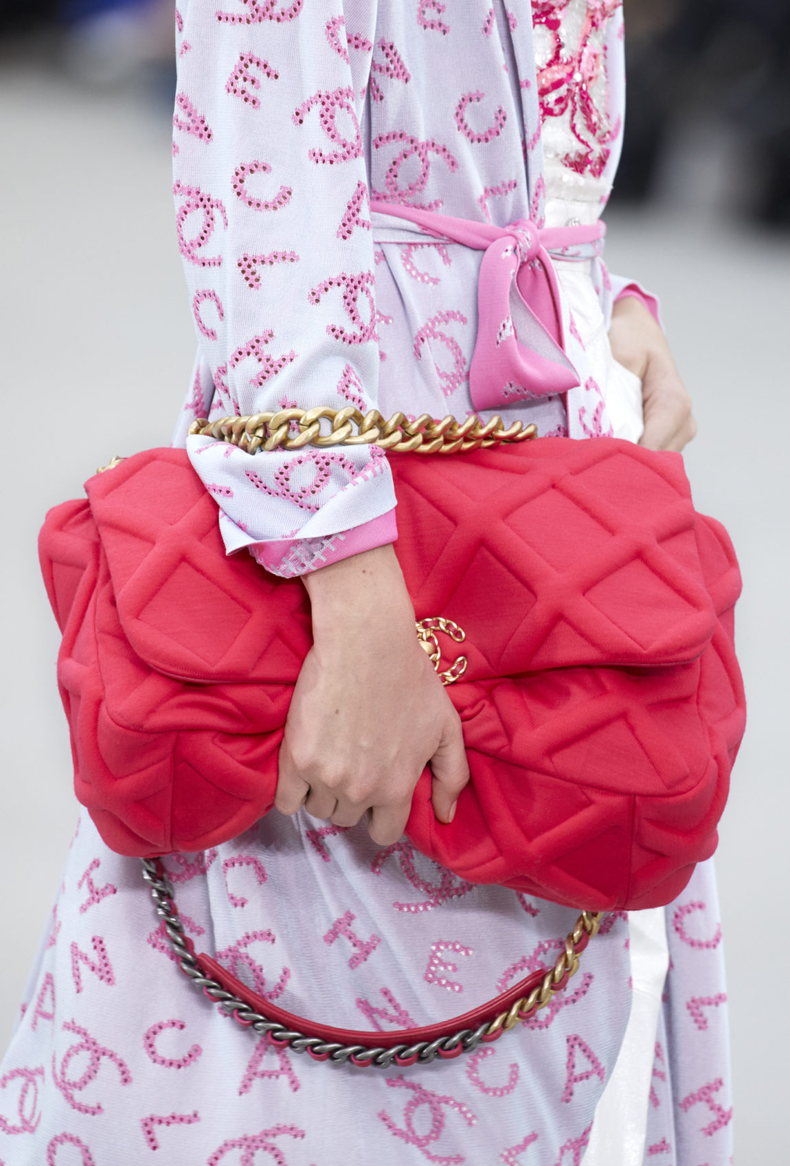 CHANEL 19 Flap Bag showcased on a modern PRADA runway.