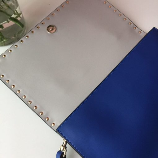 VALENTINO The Rockstud Leather Clutch. Authentic quality luxury bag crafted in genuine leather comes with authenticity card, dust bag and gift bag. Iconic Elegance in Every Detail. This Rockstud Leather Clutch is a compact and luxurious clutch made with high-quality leather and adorned with signature Rockstud detailing. It features a detachable wrist strap and is perfect for carrying essentials. The sleek design and brand logo embossing make it an ideal accessory for special occasions.